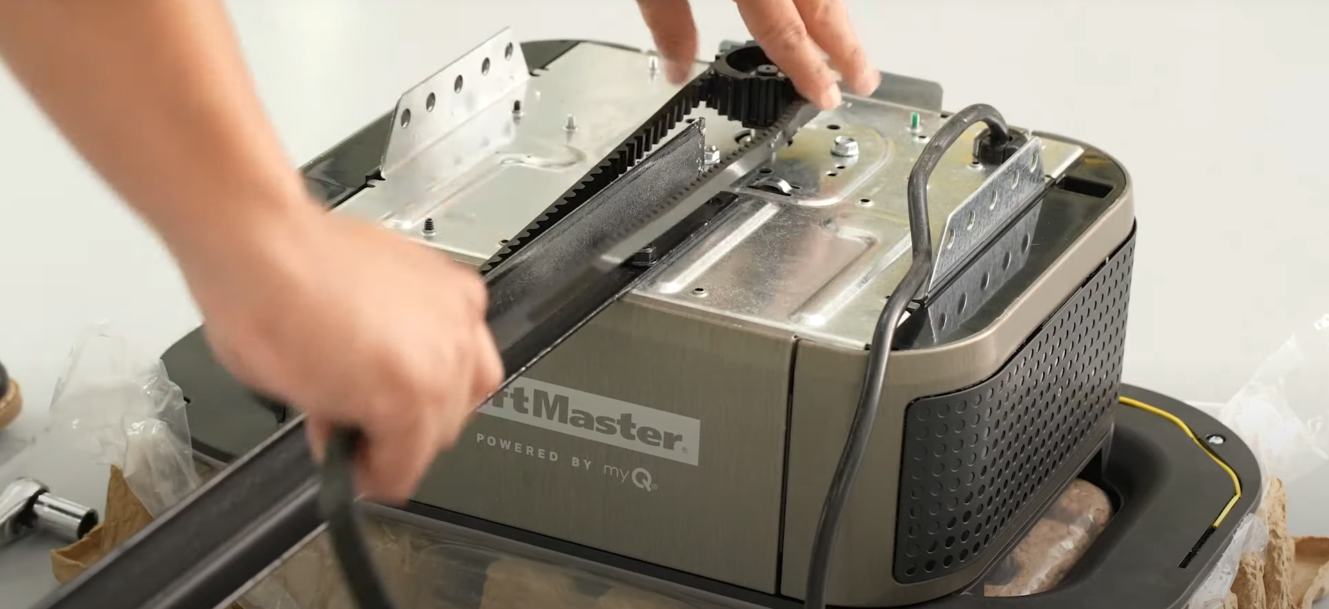 A technician performing a garage door opener repair.