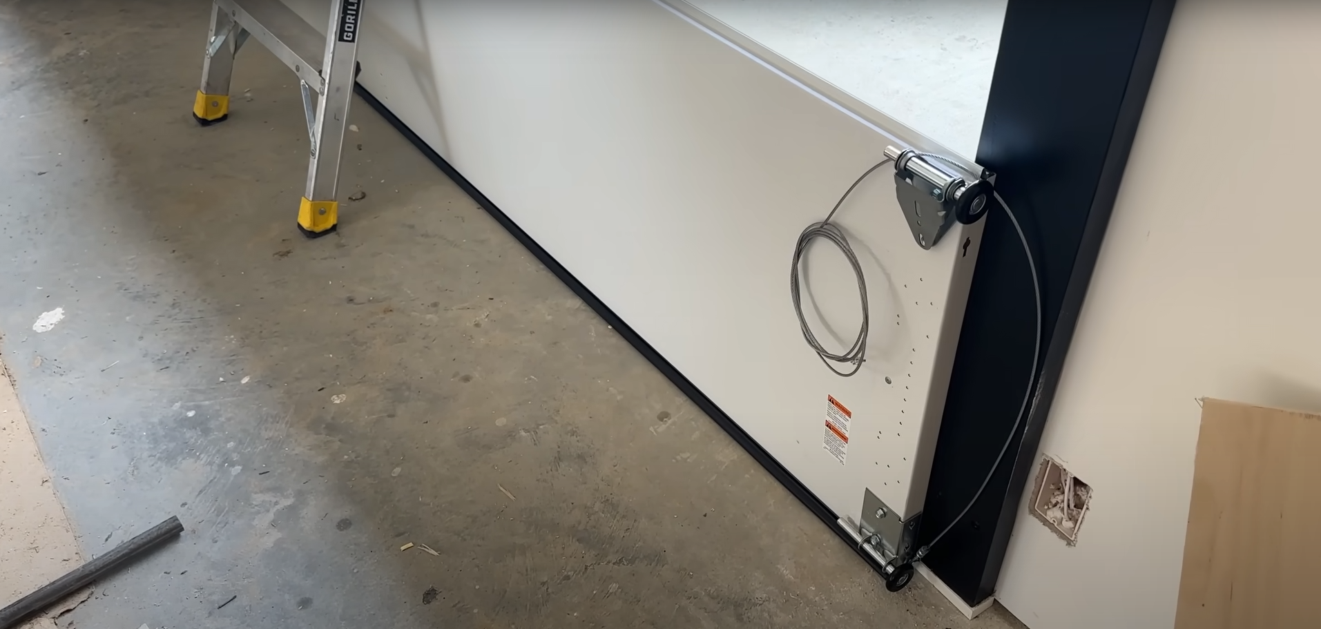 A technician repairing a damaged garage door panel.