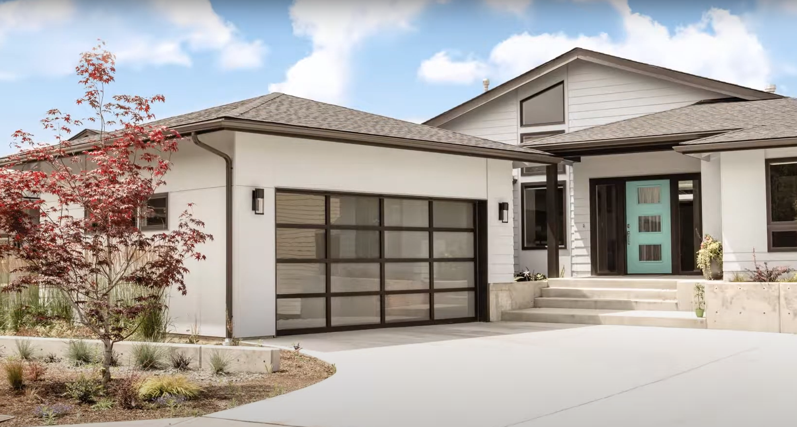 An image of a modern custom garage door with a sleek design, showcasing durable materials and a personalized finish.