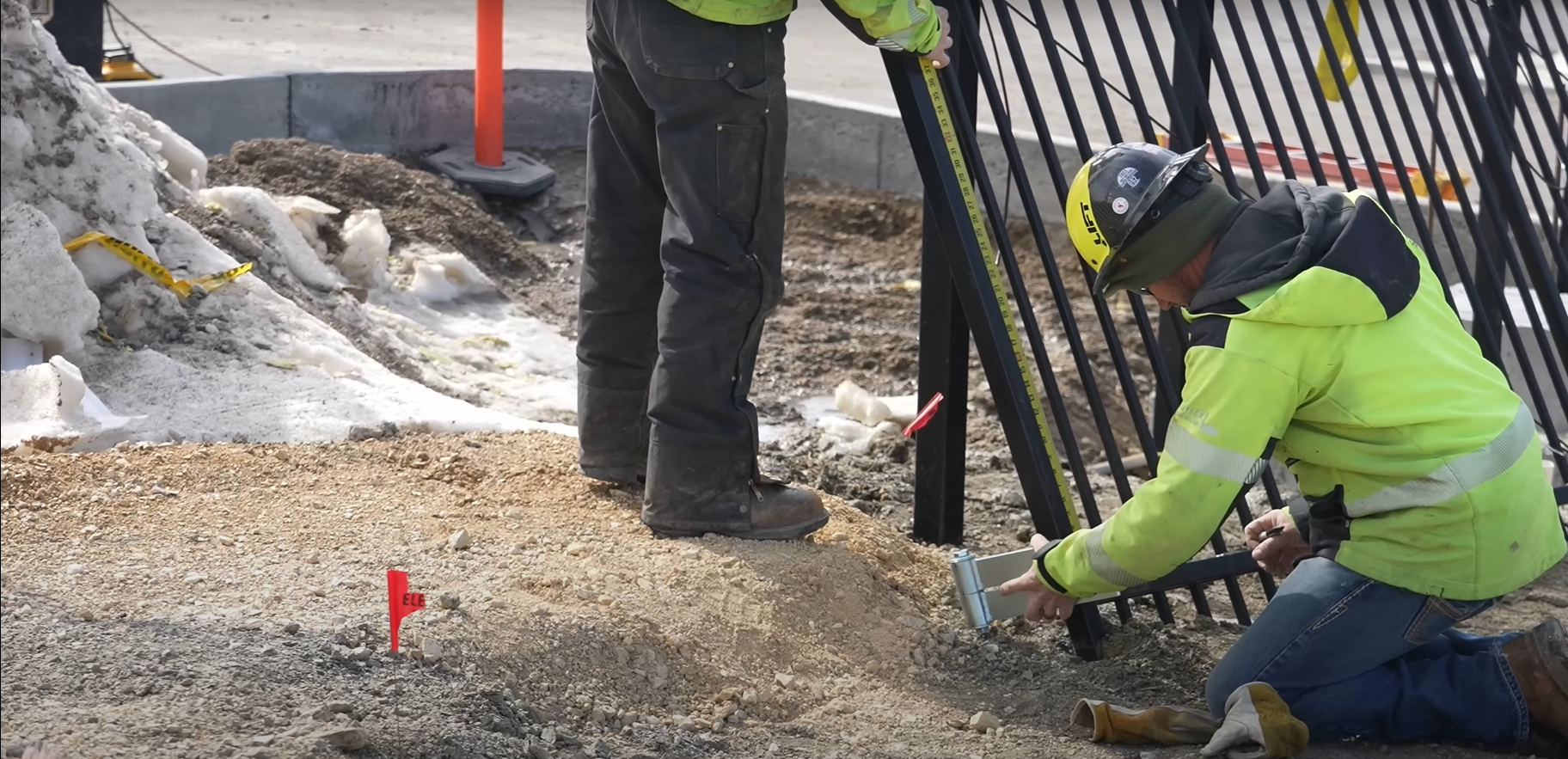 A technician performing professional gate repair on a residential driveway.