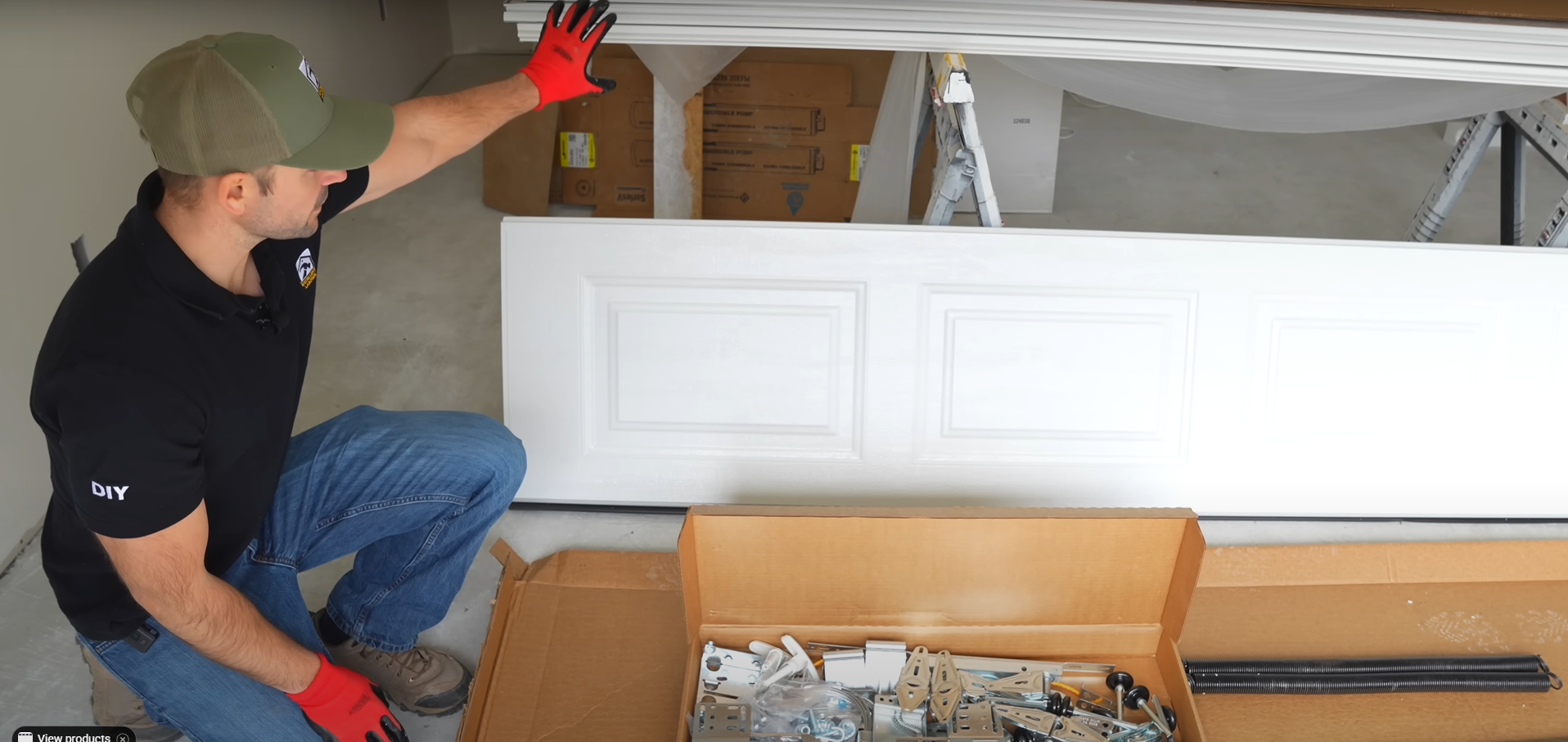 A technician repairing a damaged garage door panel.